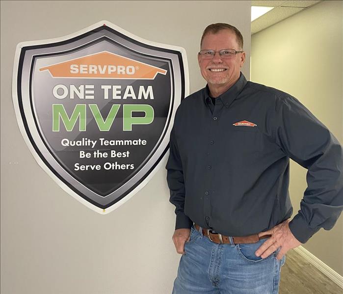 Greg williams standing in from of SERVPRO sign